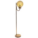 A LATE 20TH CENTURY BRASS FLOOR LAMP with globular amber glass shade and circular base, 134cm high