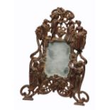 A CONTINENTAL CAST IRON MIRROR decorated dancing 18th Century figures on strut support, 36 x 27cm