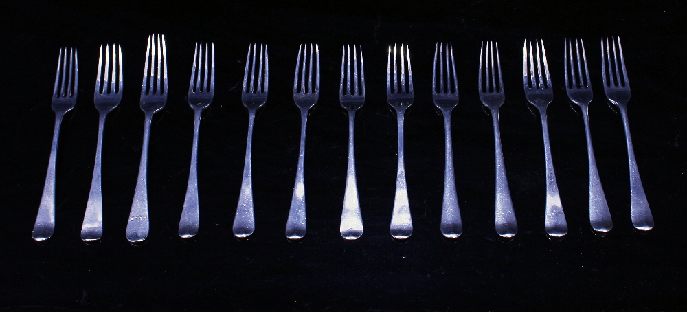 A MATCHED SET OF THIRTEEN GEORGIAN SILVER SMALL FORKS with marks for London 1815 and makers mark,