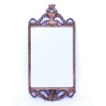 A GEORGIAN STYLE GILT FRAMED WALL MIRROR with an urn crest and swag decoration, 38cm x 81cm