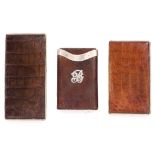 TWO FORTNUM AND MASON CROCODILE SKIN COVERED CIGARETTE CASES the largest 17.5cm long together with a