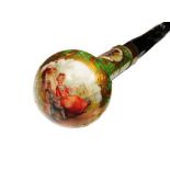 A 19TH CENTURY PORCELAIN HANDLED WALKING CANE the green glazed and gilt heightened handle with