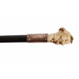 A LATE 19TH/EARLY 20TH CENTURY ANTLER HANDLED WALKING CANE the handle carved as an amusing