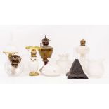 TWO POTTERY OIL LAMPS in the form of owls, an early 20th century brass oil lamp, a moulded glass oil