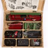 A COLLECTION OF RED AND GREEN MECCANO to include two clockwork motors, an electric motor, various