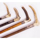 FOUR ANTLER HANDLED RIDING CROPS each with silver collars (4)