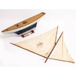 AN EARLY TO MID 20TH CENTURY MODEL POND YACHT with blue and silver painted hull, 79cm long