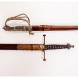 TWO 19TH CENTURY DRESS SWORDS in leather scabbards, both with engraved decoration to the blade and