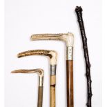 A SMALL GROUP OF RIDING CROPS and a walking stick