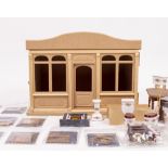 A MODERN WOODEN PART BUILT DOLL'S HOUSE SHOP KIT together with various doll's house accessories 41cm