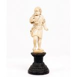 A LATE 19TH / EARLY 20TH CENTURY CONTINENTAL IVORY FIGURE of a male figure holding a goblet on a