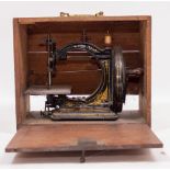 A GRESHAM MANCHESTER VICTORIAN CAST IRON SEWING MACHINE in a mahogany box, the box 35cm wide