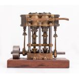 A WELL MADE CAST IRON AND BRASS TWIN CYLINDER LAUNCH ENGINE mounted on a wooden plinth base, the