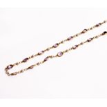 A YELLOW METAL PEARL AND AMETHYST COLOURED STONE NECKLACE stamped 750, 60cm long overall