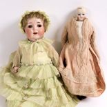A 19TH CENTURY FRENCH FASHION DOLL in pink and lace fabric dress, with porcelain head glass eyes