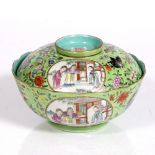 A Chinese porcelain famille rose bowl and cover decorated with two oval reserves showing figures