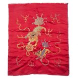 A Chinese red silk panel late 19th/early 20th Century with gold thread depicting temple dogs and