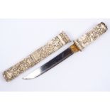 A Japanese ivory dagger (tanto) late 19th Century carved with figures, geese and domestic scenes