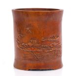 A Chinese bamboo brush pot 19th/20th Century carved with lotus blooms in water and swallows above,