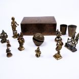 A collection of Indian and Benin bronze weights and other pieces in an engraved Indian Benares brass