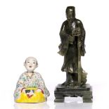 A Chinese biscuit porcelain nodding boy 20th Century 11cm and a Chinese green hardstone model of