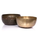 A Himalayan singing bowl early 20th Century 32cm and one other Himalayan singing bowl 29.5cm,