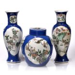 A garniture of three Chinese famille rose vases 19th Century each of powder blue ground with
