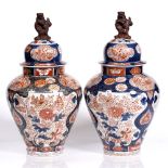 A pair of Japanese Imari vases and covers 18th Century of pear shaped form, with kylin finials and