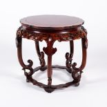 A Chinese hardwood small urn stand early 20th Century carved with ruyi designs around the edge, 37cm