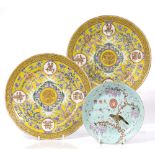 A pair of Chinese yellow ground dishes Guangxu (1875-1908) each with roundels of symbols and central