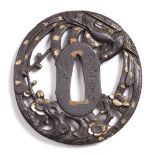 A Japanese bronze tsuba by Shoishi Yosinobu, phoenix and plum,shakudo decoration 7cm