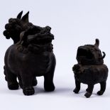 A bronze temple dog 19th Century in the Ming style, 20cm and a smaller similar temple dog 12cm