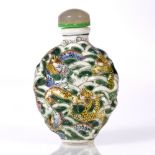 A Chinese porcelain oviform snuff bottle 19th Century moulded and decorated wu-cai style with