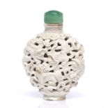 A Chinese Jingdezhen white glazed porcelain oviform snuff bottle decorated with dogs of fo,