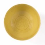 A Chinese yellow monochrome bowl 18th/19thCentury with central flower head, Qianlong seal mark 11.