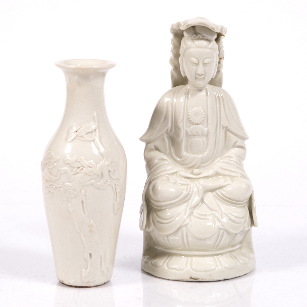 A Chinese Dehua figure of a seated Guanyin 19th Century 21cm high and a Chinese white glazed vase,