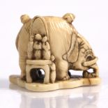 A Japanese ivory netsuke of an elephant Meiji upon which two figures sit and to one side others