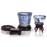 Two Chinese blue and white wine cups 19th Century an inlaid wood stand and three other small stands