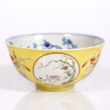 A Chinese porcelain medallion bowl decorated with goats standing and reclining beneath symbolic