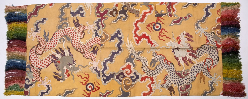 A Tibetan silk canopy circa 1930 consisting of a central panel of silk brocade with designs of