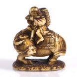 A Japanese netsuke of Roshi late Meiji seated upon an ox playing a flute, on a shaped base, 3cm