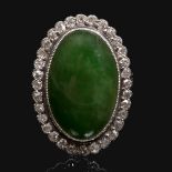 A Chinese jade and diamond cluster ring of oval cabochon form Accompanied by a testing report from