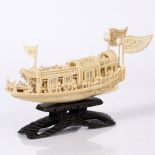 A Chinese ivory carved model junk late 19th Century on a hardwood stand, 19cm