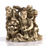 A Japanese ivory okimono of Benzaiten (Goddess of Love) late Meiji period seated beside a large