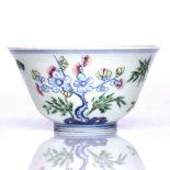 A Chinese Doucai small bowl late 19th Century decorated with bamboo and blossom, Qianlong mark,