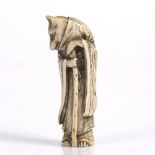 A Japanese ivory netsuke of a standing Fox Priest late Meiji wearing a robe, scarf and holding a