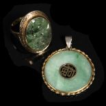 A Chinese jade annular pendant with central pierced motif and rope twist border and a green