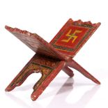 An Indian polychrome painted manuscript stand 19th Century decorated with central swastika and