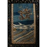 A Chinese textile panel 18th/19th Century embroidered with a five clawed dragon and celestial waves,