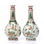 A pair of Chinese famille verte bottle vases Kangxi (1662-1722) with panels of flowering peonies and